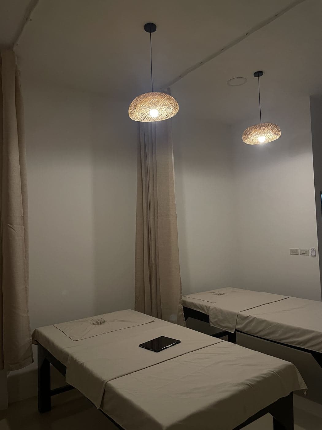 Massage beds under rattan pendant lamps