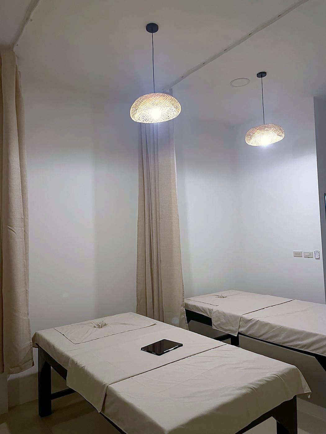 Massage beds under rattan lamps